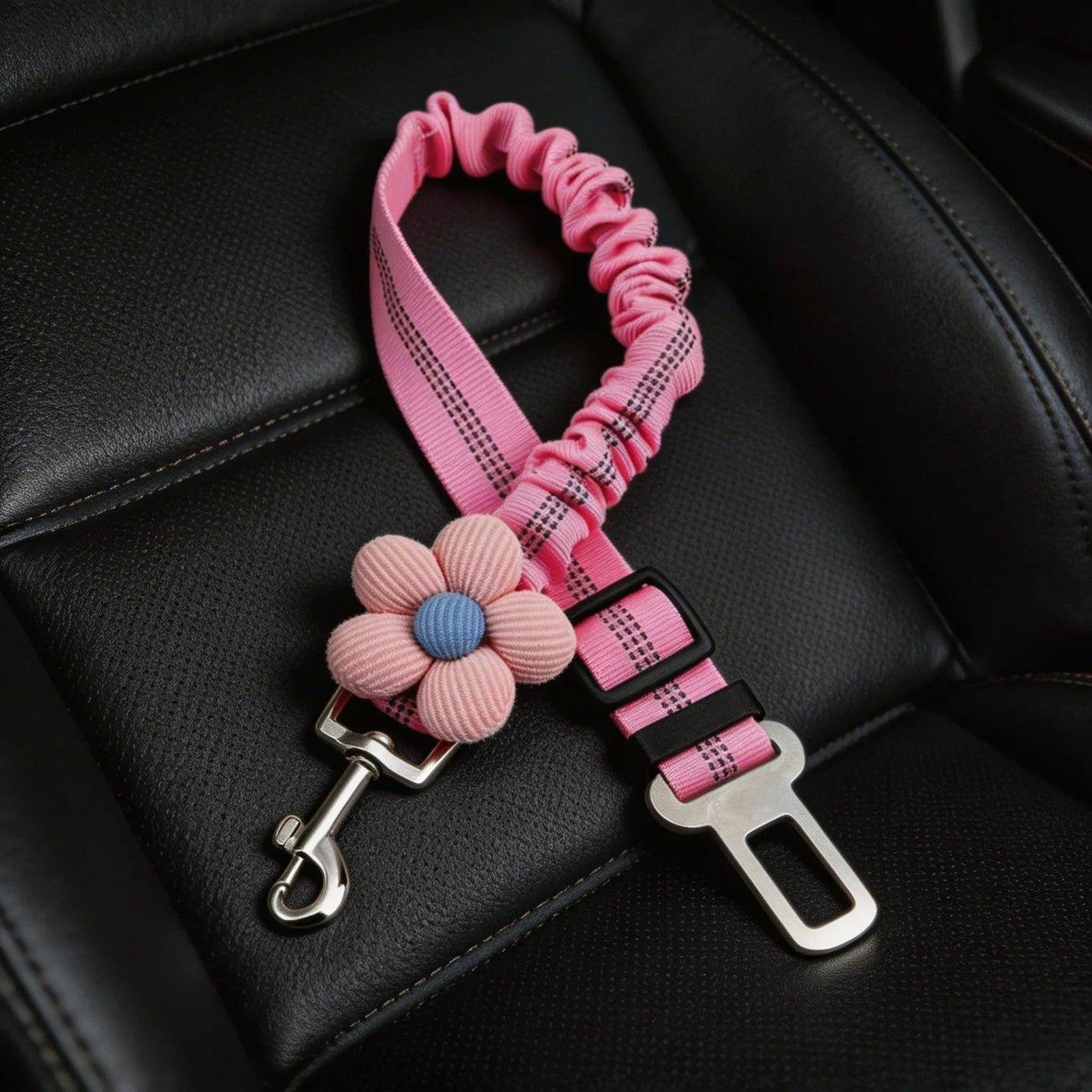 Pink pet seat belt with flower accessory on black car seat, cute dog car safety strap